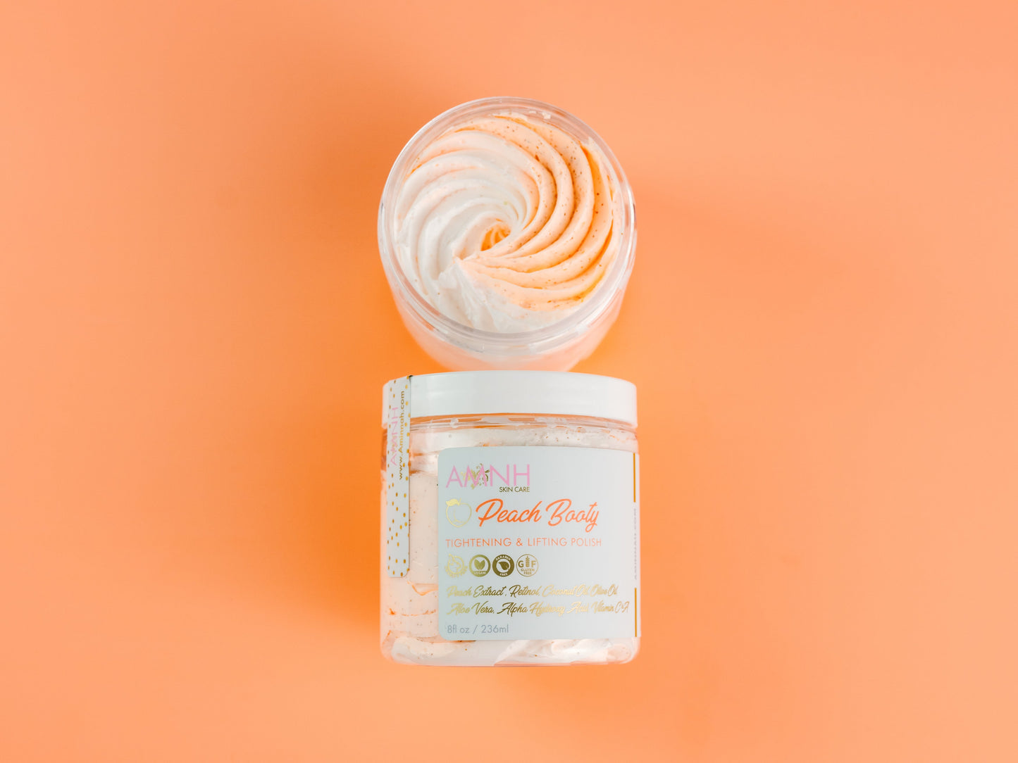 Jar with an orange whipped swirl piled on top, on orange.