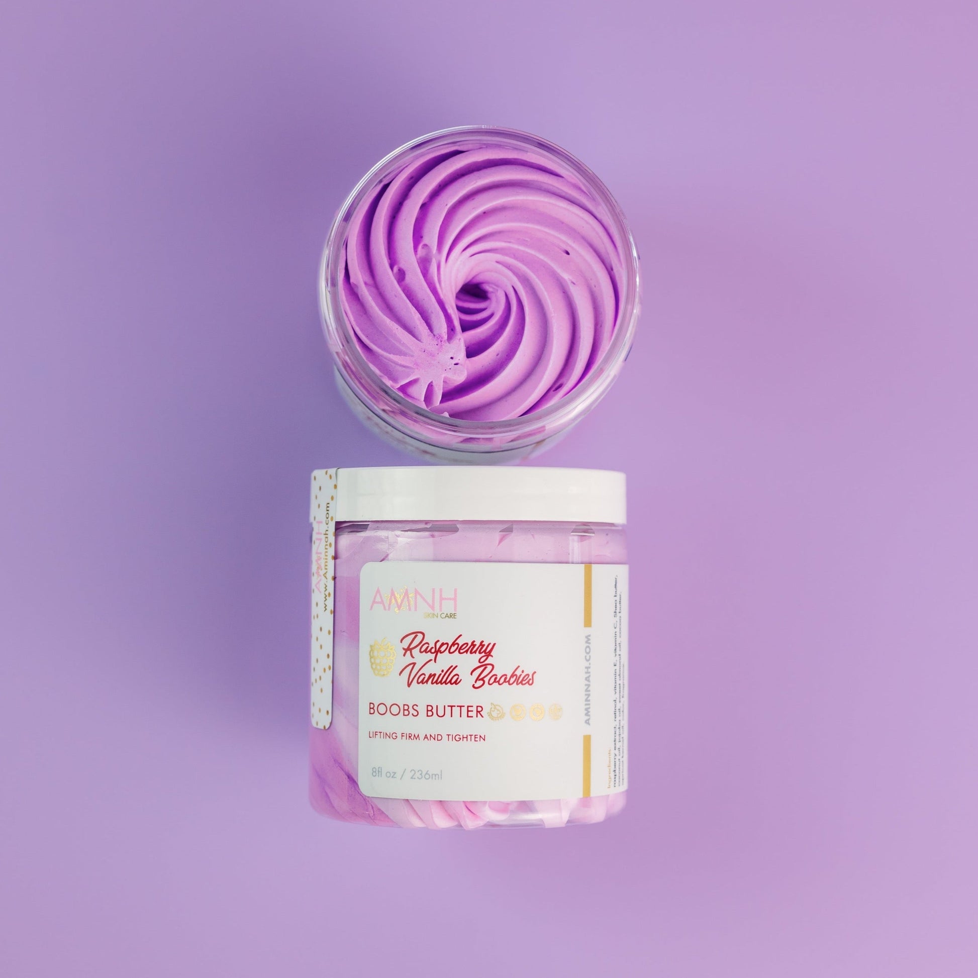 Jar topped with a tall purple whipped swirl on a purple background.