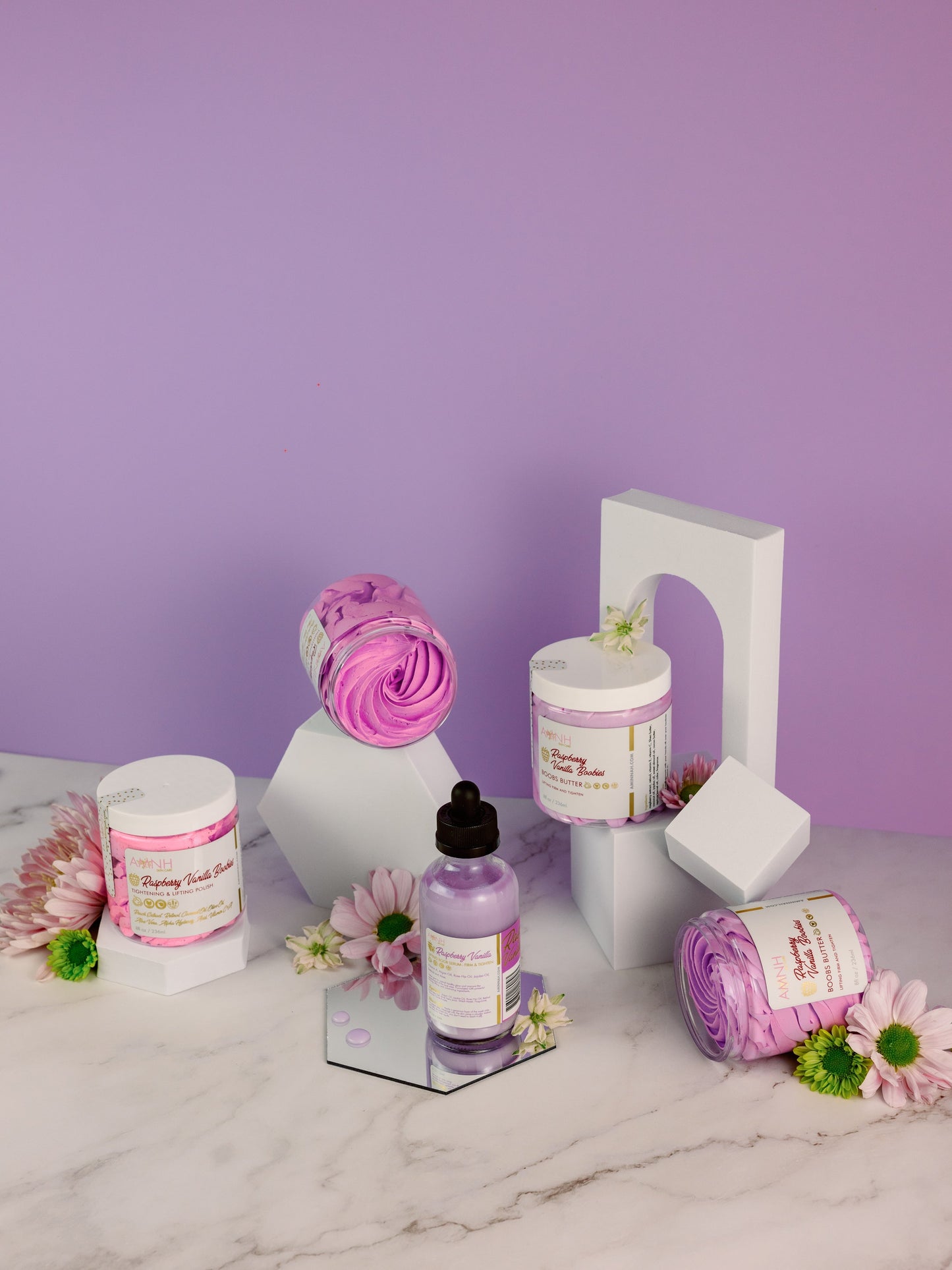 Jars, a dropper bottle and small flowers arranged on lilac.