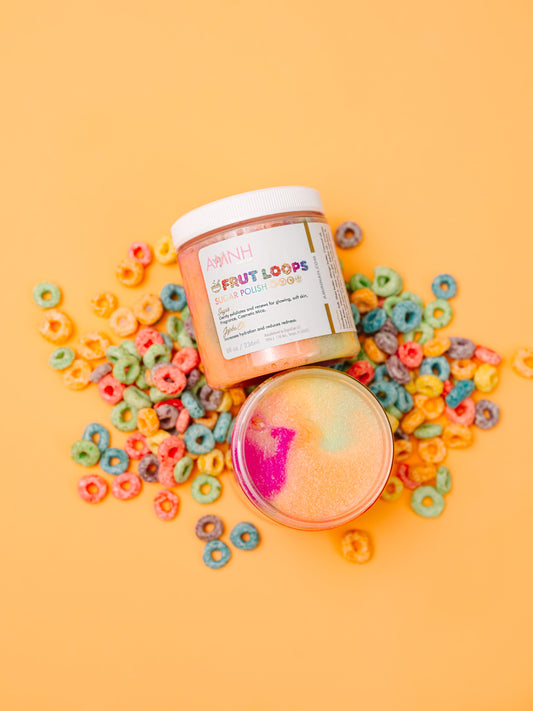 Jar of scrub with cereal loops and sprinkles scattered around it on orange.