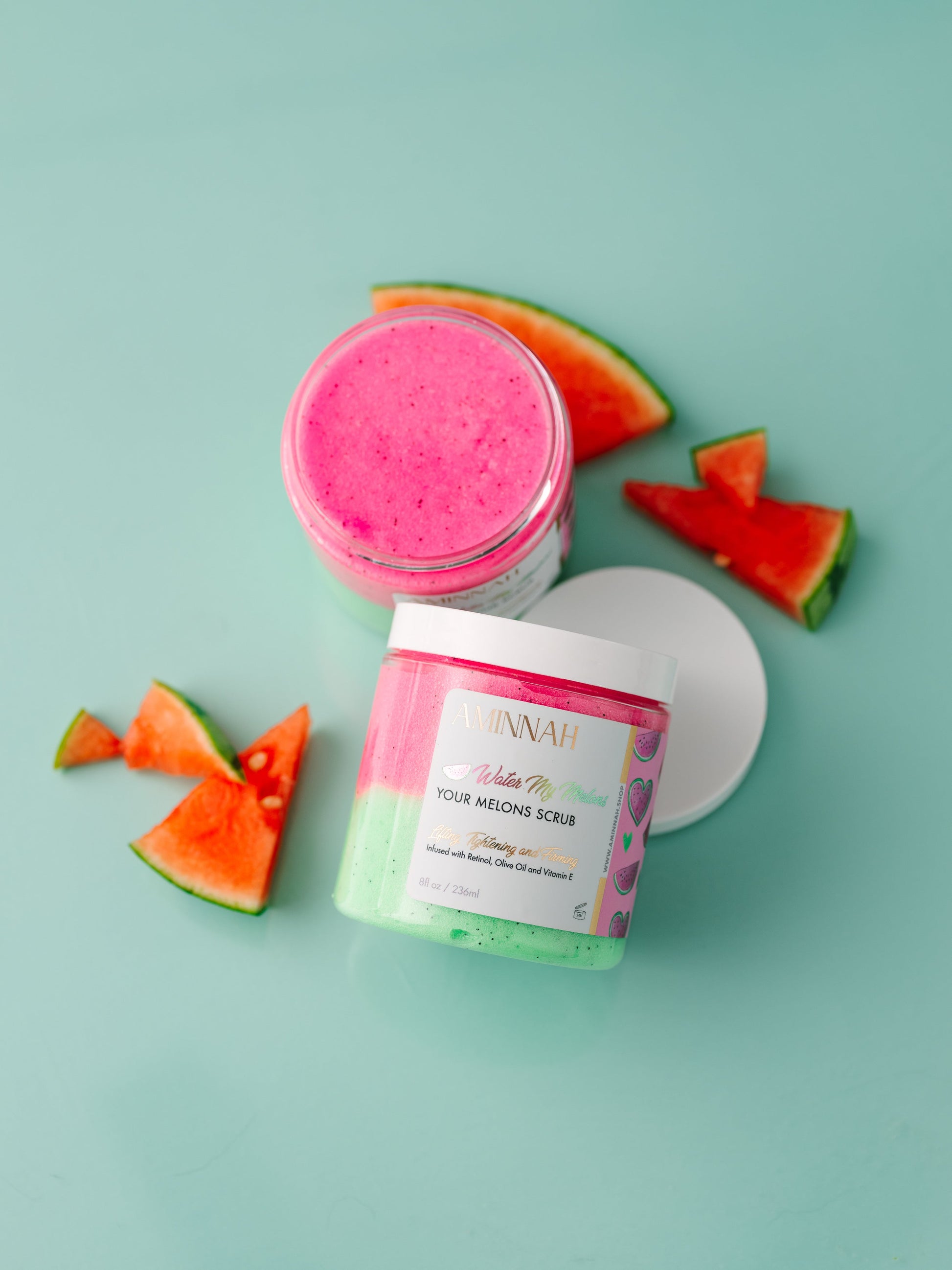 Jar with the lid and watermelon pieces beside it on mint.