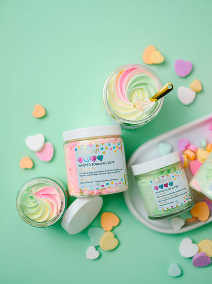 Jars of whipped butter with candy sprinkles scattered around them on mint.