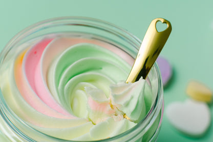 Overhead view of the pastel swirl in the jar with a gold spoon resting on it.