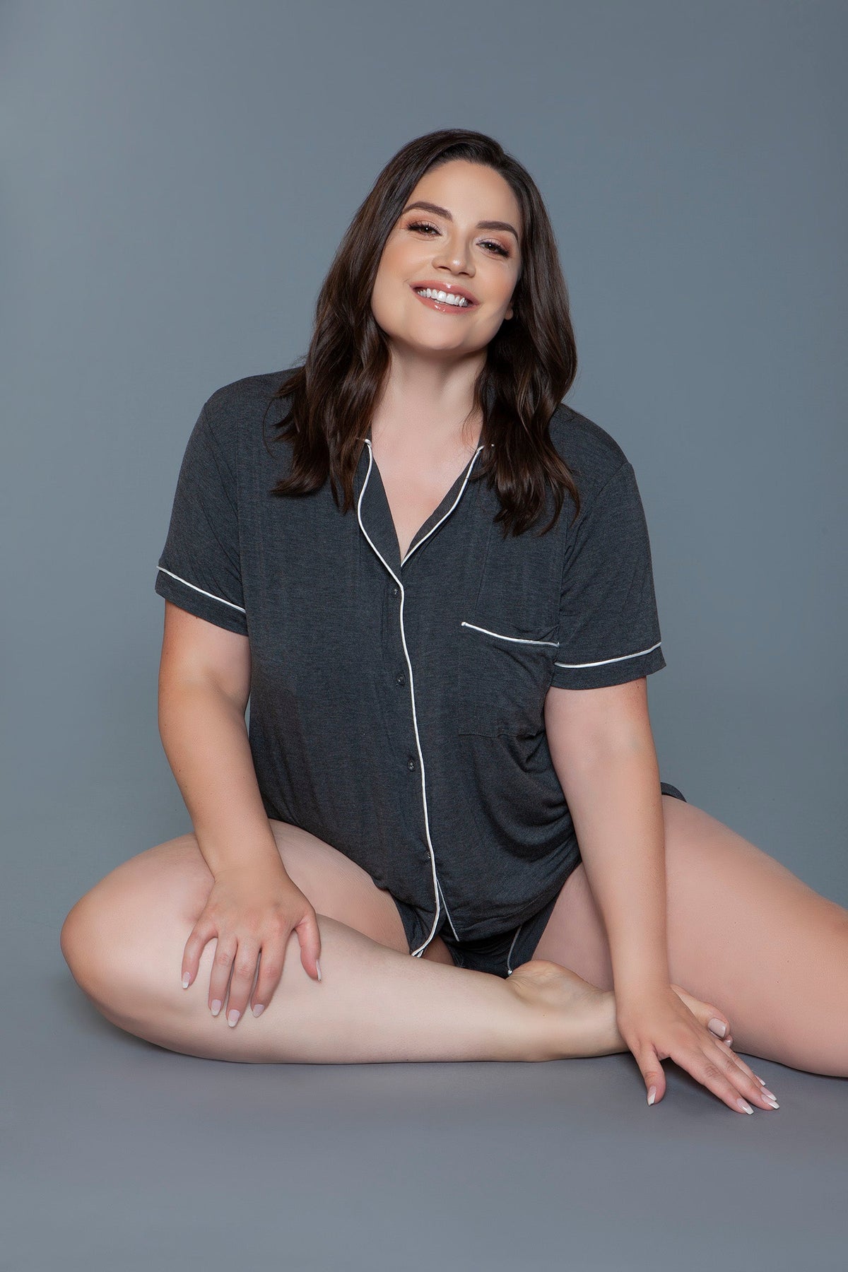 Charcoal knit pajama set, seated front view showing the notched collar and chest pocket