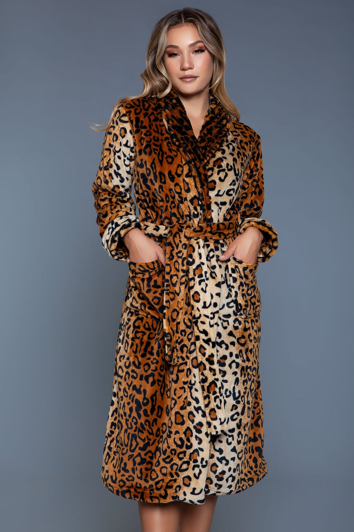 Leopard print plush robe on a gray backdrop, front view with both hands in the front pockets