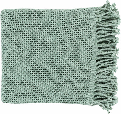 Folded aqua green cotton knit throw blanket with a textured stitch and twisted fringe along one end
