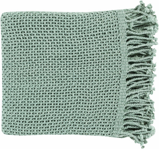 Folded aqua green cotton knit throw blanket with a textured stitch and twisted fringe along one end