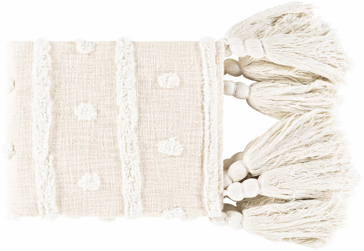 Folded cream throw blanket with tufted dots, raised stripes and a row of big knotted tassels