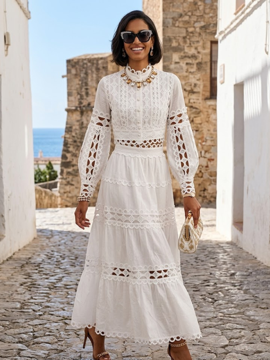 Women's white eyelet two-piece set by BYMANYC New York, long-sleeve top over a tiered maxi skirt.