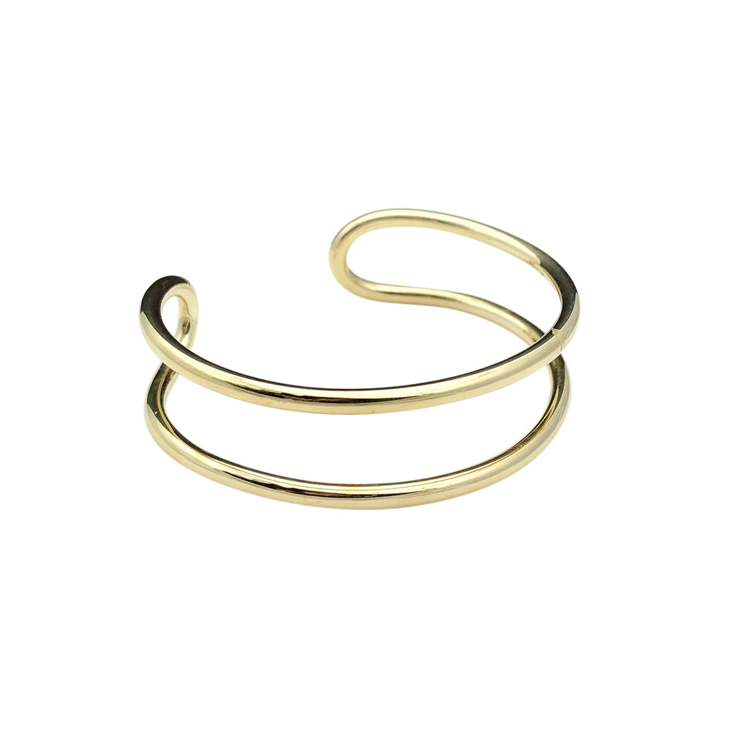 Double wire brass cuff bracelet on white, two parallel bands joined by a loop at one end