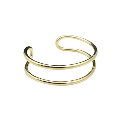 Double wire brass cuff bracelet on white, two parallel bands joined by a loop at one end