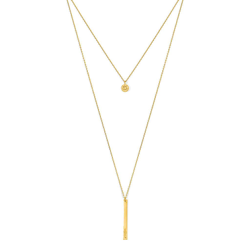 Layered bar necklace on white, a short chain with a round charm above a long chain with a bar