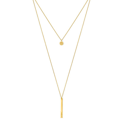 Layered bar necklace on white, a short chain with a round charm above a long chain with a bar