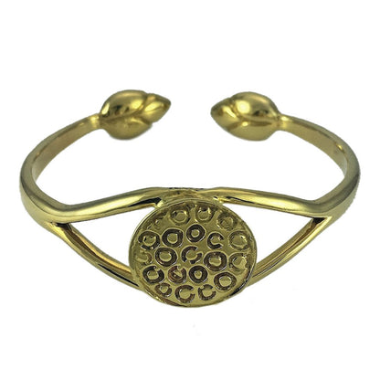 Lotus cuff bracelet in polished brass, front view of the seed pod disc and the two bud tips