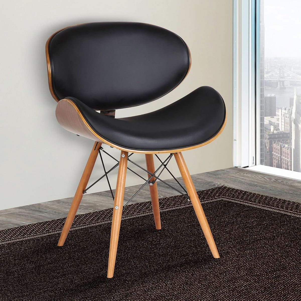 Dining chair in black faux leather showing the molded seat and back shell.