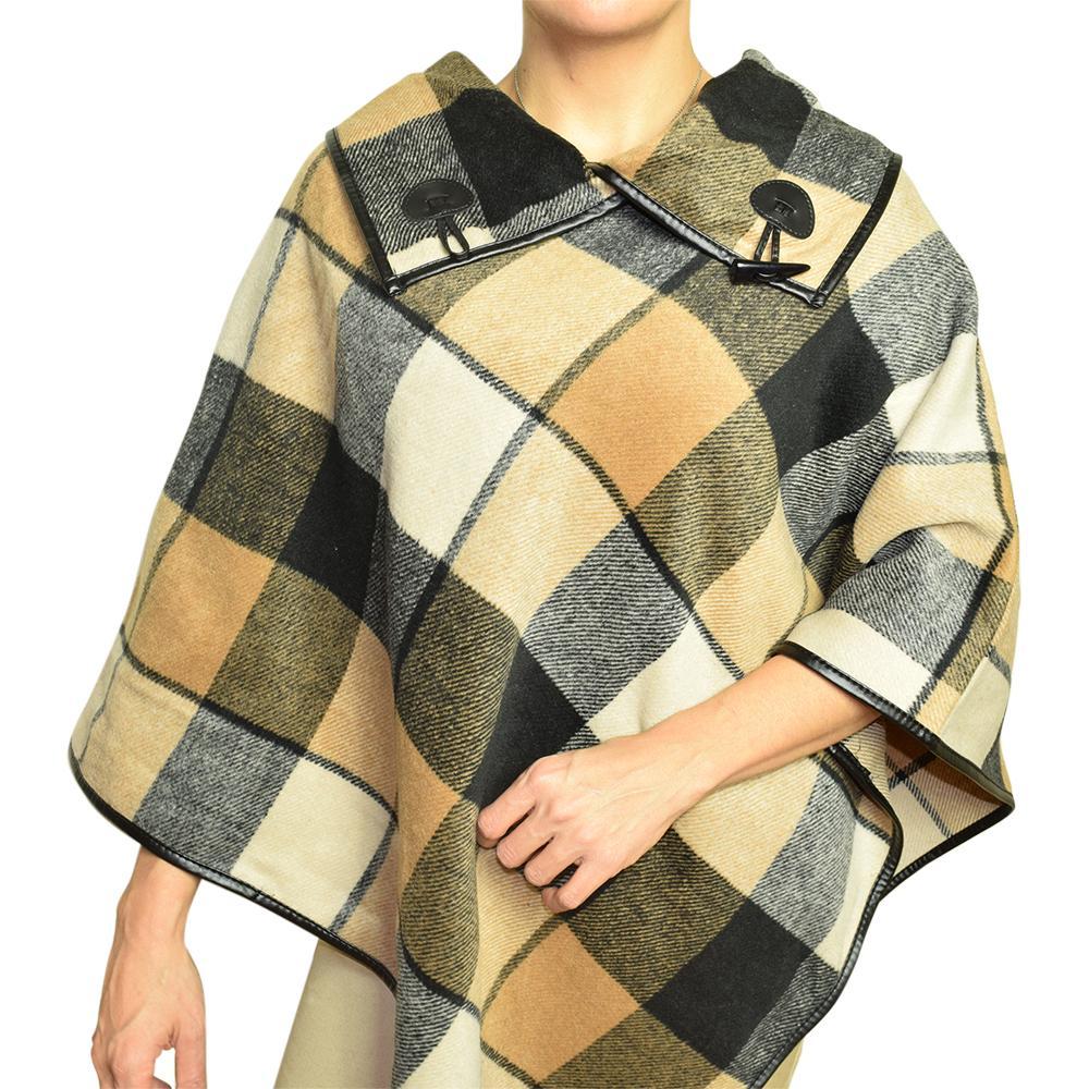 Model in the plaid cape poncho, camel, black, cream and gray checks with a collar closed by two toggles