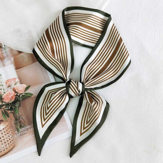 Olive colorway, a narrow silk neck scarf with brown stripes on cream and a dark olive edge, knotted