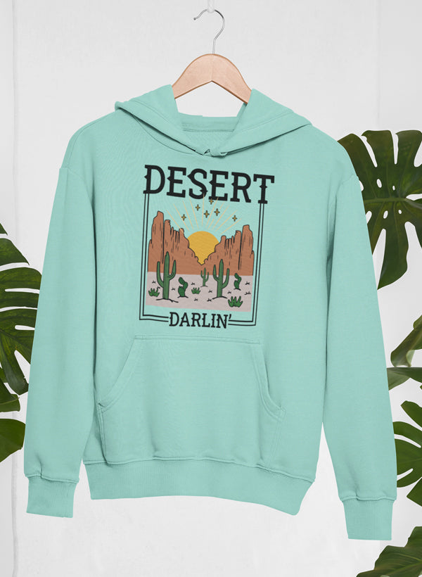 Heather Prism Dusty Blue fleece hoodie on a hanger, framed desert scene on the chest.