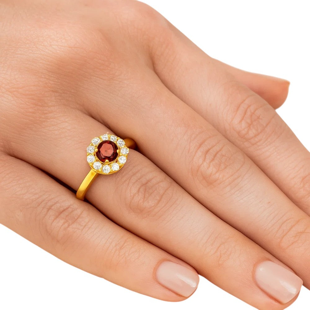 Hessonite garnet halo ring worn on a woman's finger