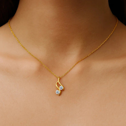 Woman wearing the swirl pendant necklace with white stones, a small drop below the collarbone