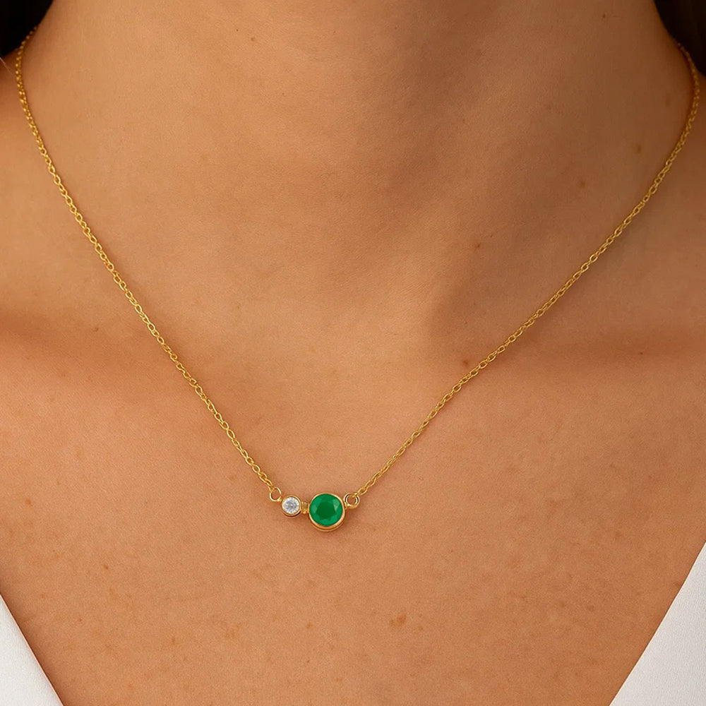 Woman wearing the two stone necklace in green onyx, a small round pair resting at the base of the neck