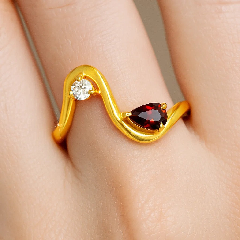 Wave ring with a pear hessonite garnet and a round CZ worn on a finger