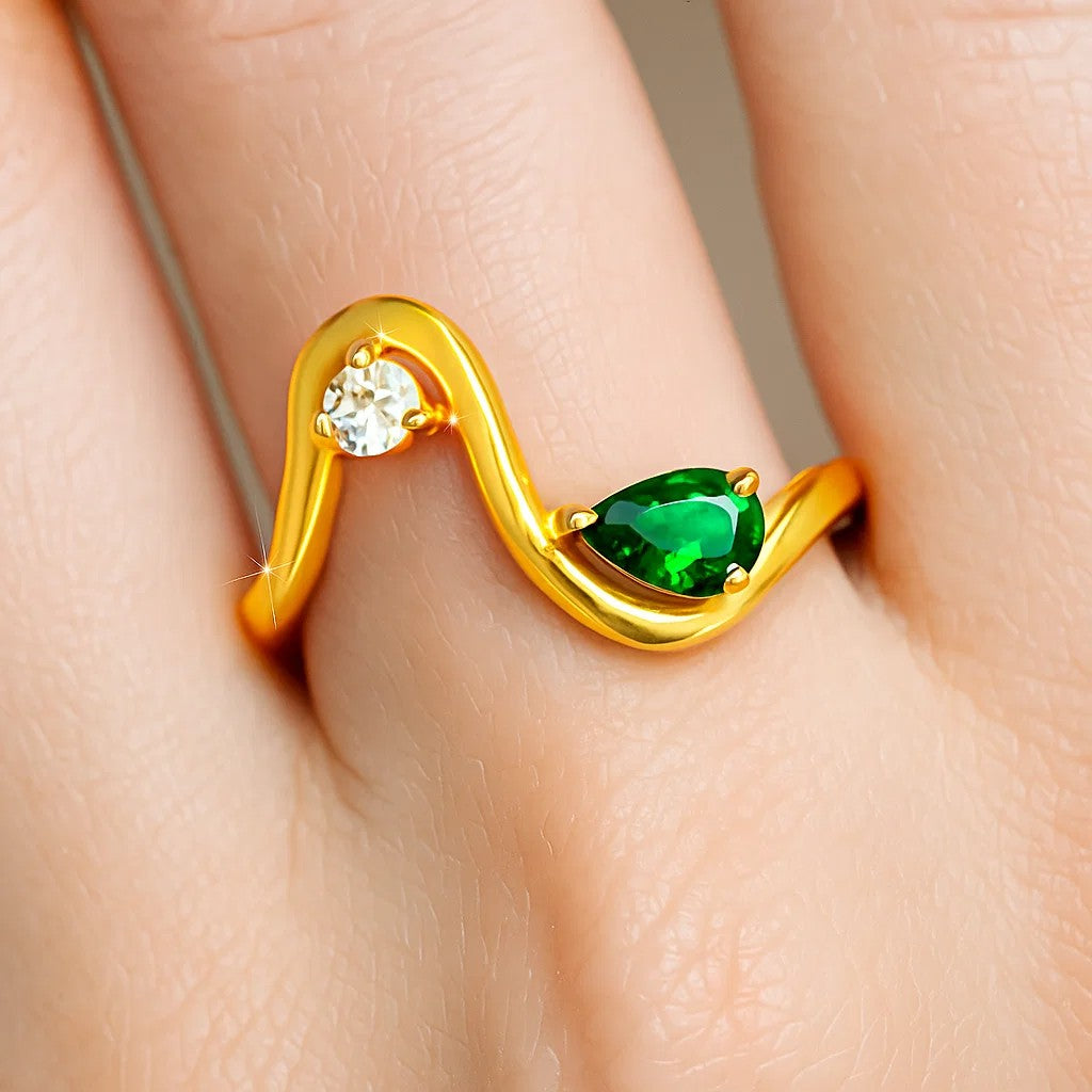 Wave ring with a pear green tourmaline and a round CZ worn on a finger