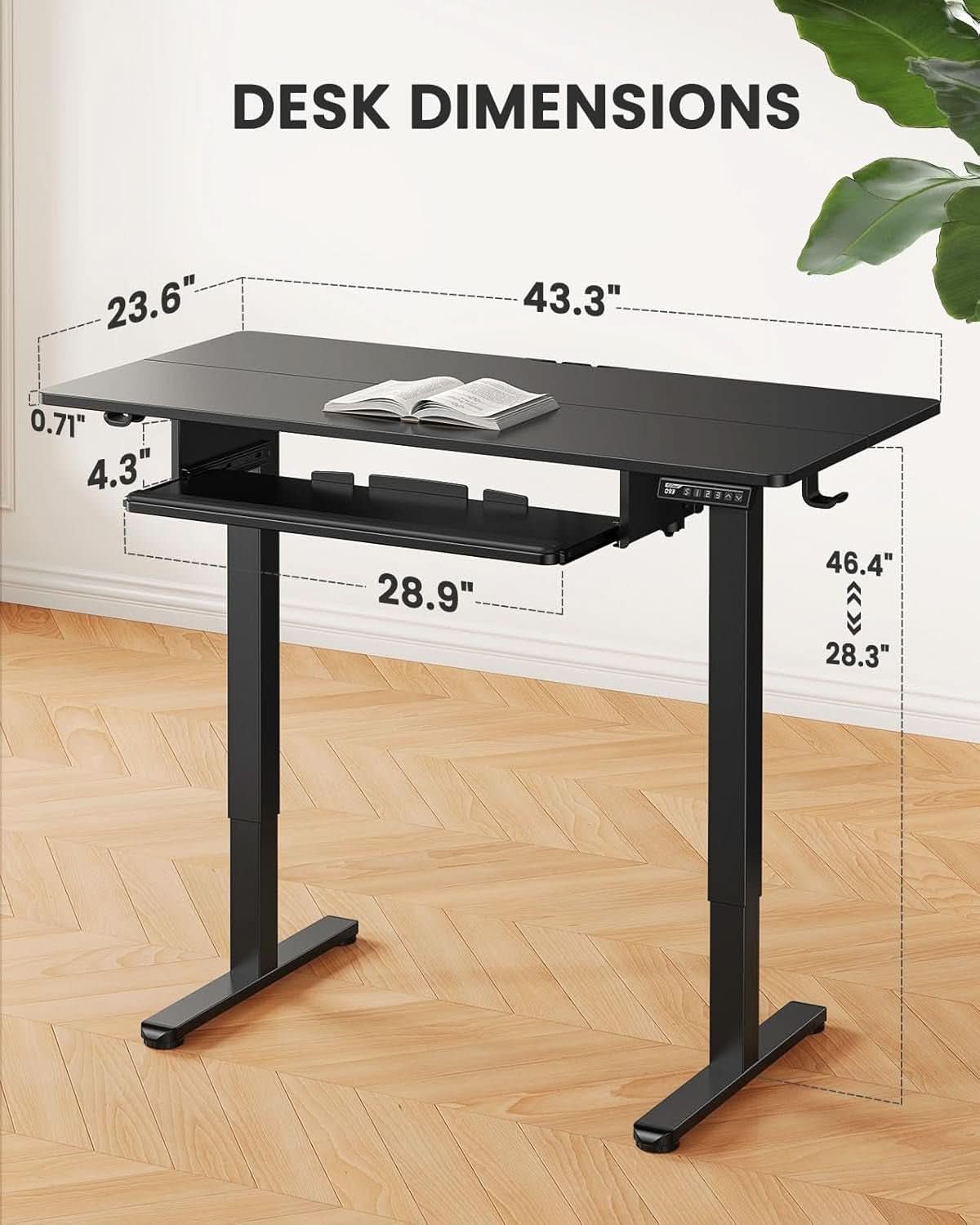 Electric standing desk on a steel frame showing the tray under the desktop.