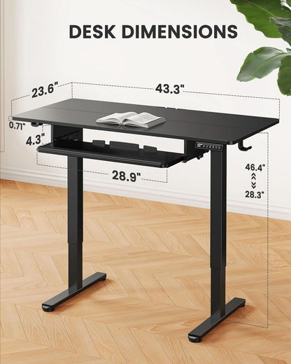 Electric standing desk on a steel frame showing the tray under the desktop.