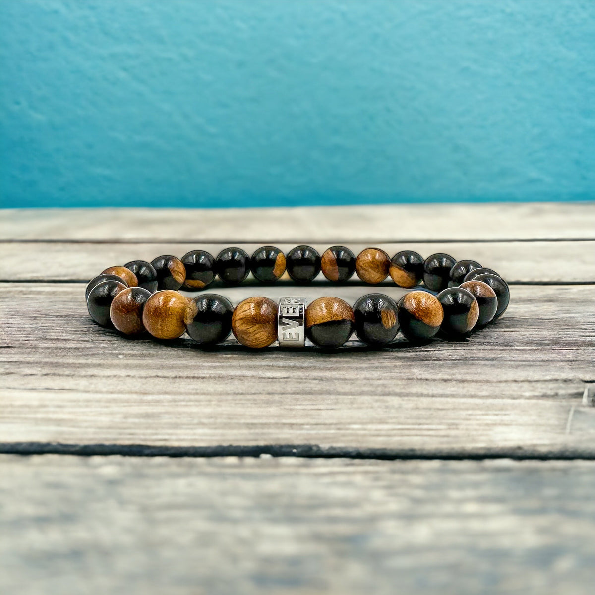 Cascade Steelroot ebony sapwood beaded bracelet, shown on a wood surface