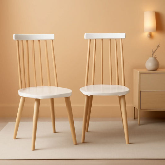 Two spindle back dining chairs in rubber wood finished natural with white painted accents.