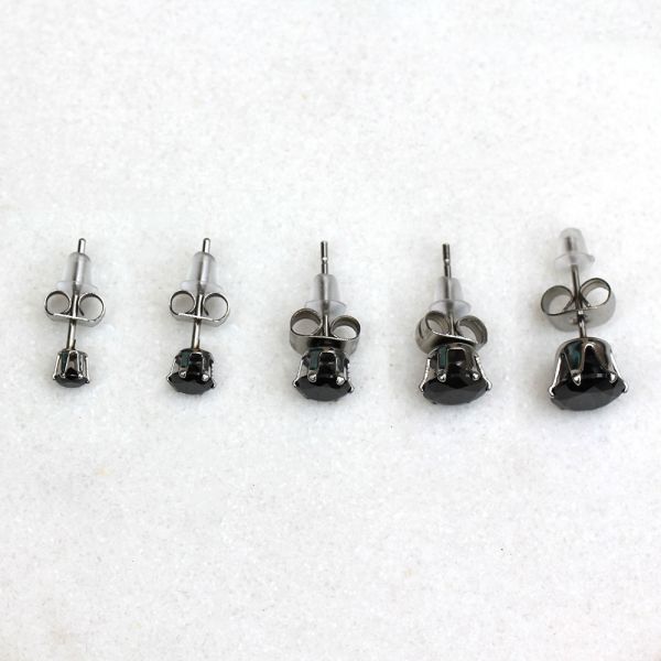 Black CZ studs in five sizes from 3mm to 7mm lined up in a row on white