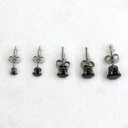 Black CZ studs in five sizes from 3mm to 7mm lined up in a row on white