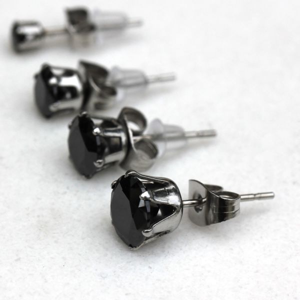 Black round CZ studs with steel clutches, showing the slim posts