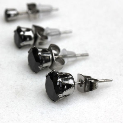 Black round CZ studs with steel clutches, showing the slim posts