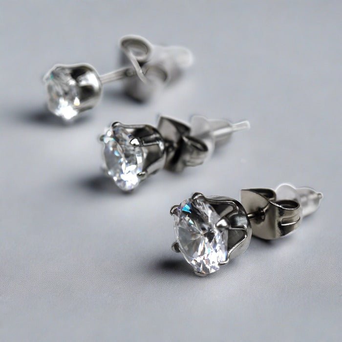 Clear round CZ stud earrings in three sizes with six prong heads and steel clutches