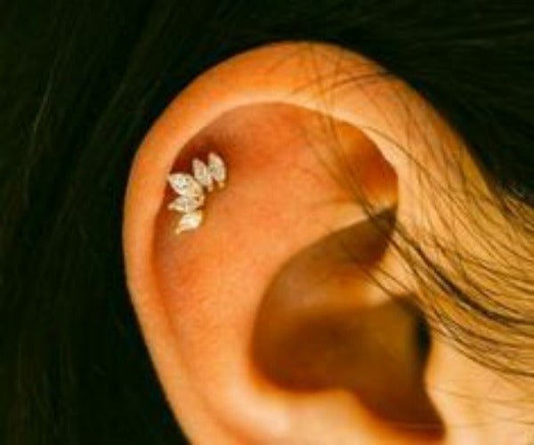 Crown helix earring with five clear marquise CZ stones worn on the upper ear