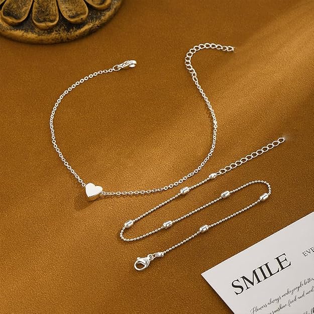 Silver tone double chain heart anklet laid flat, showing the heart, the beaded chain and the extender