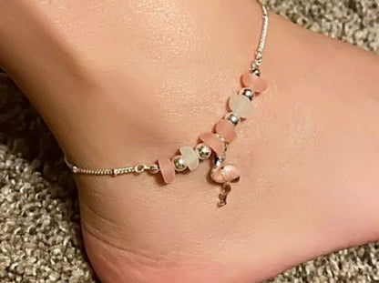 Flamingo anklet with frosted pink and white glass beads worn on a bare ankle