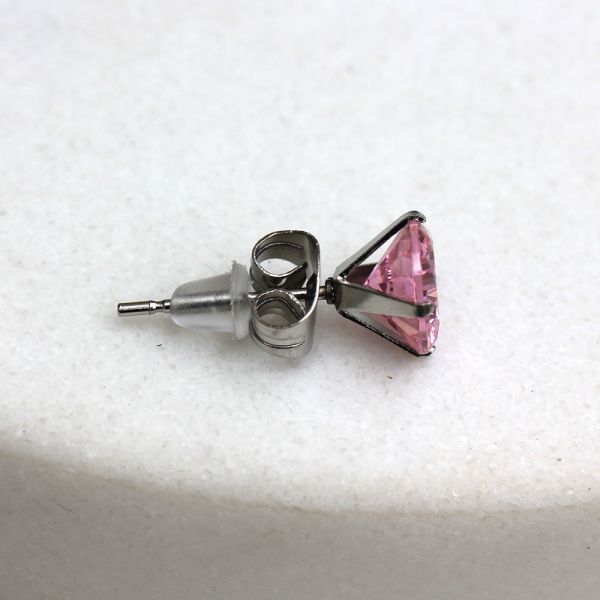 Side view of a pink CZ stud showing the post, the clutch and the clear rubber back