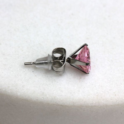 Side view of a pink CZ stud showing the post, the clutch and the clear rubber back
