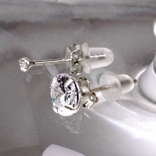 Sterling silver CZ studs with clear rubber backs, a tiny 2mm stud beside a larger stone