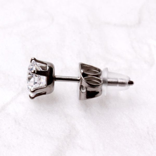Side view of a titanium CZ stud with a clear rubber back on the post