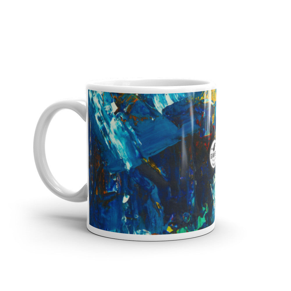 Glossy white ceramic mug with a blue and white painting wrapped around the outside.