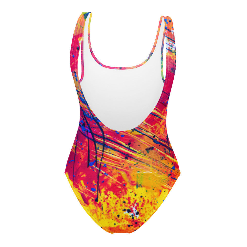 One-piece swimsuit printed in red, pink and blue splatter, with a cheeky cut back.