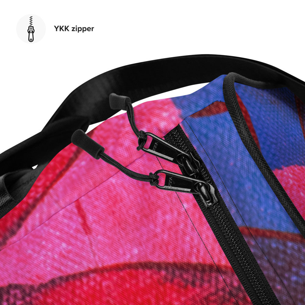 Travel duffle bag in orange, blue and cream brushwork, with an adjustable padded strap.