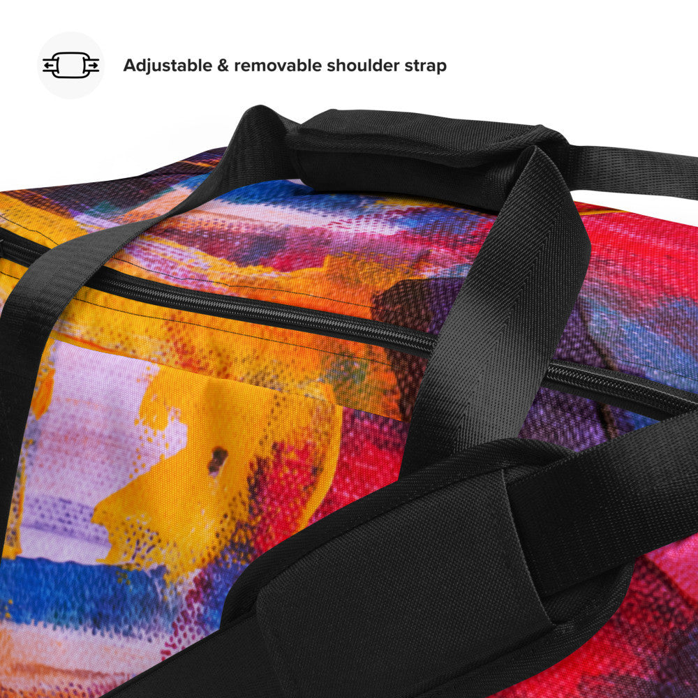 Travel duffle bag in orange, blue and cream brushwork, with an adjustable padded strap.