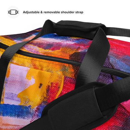 Travel duffle bag in orange, blue and cream brushwork, with an adjustable padded strap.