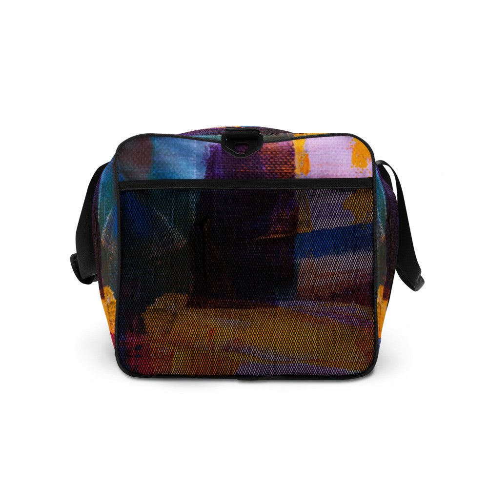 Travel duffle bag in orange, blue and cream brushwork, with an adjustable padded strap.