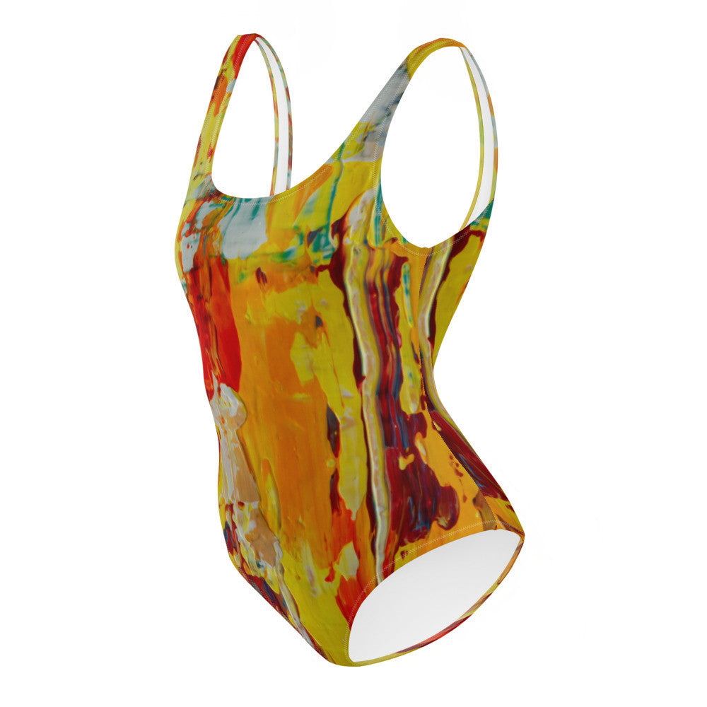 One-piece swimsuit printed in yellow, orange and red, with a cheeky cut and lined front.